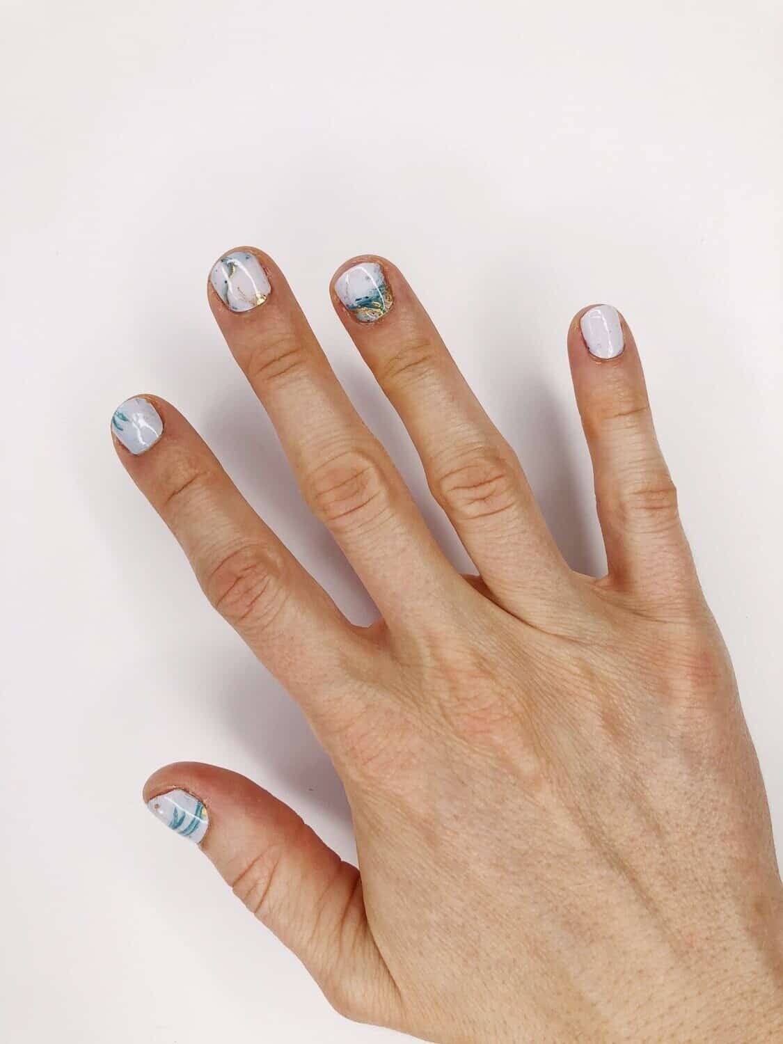 close up of a hand with ocean waves bubble pop no polish nail color wraps