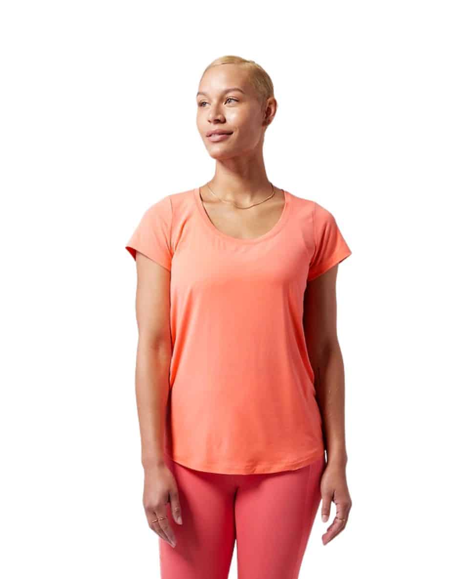 a woman in a tangerine colored athletic shirt