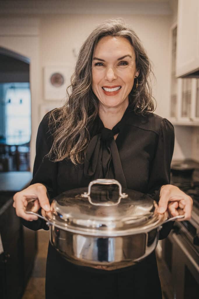 A woman with slow cooker