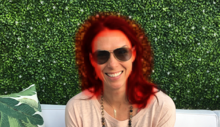 A photo of a woman with a red halo around her head and a green background.