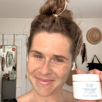 A woman with a BLUH Alchemy face mask on her face.
