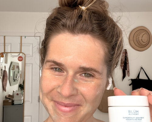A woman with a BLUH Alchemy face mask on her face.