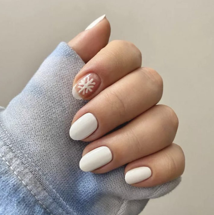 Nail art with snowflake on the pointer finger