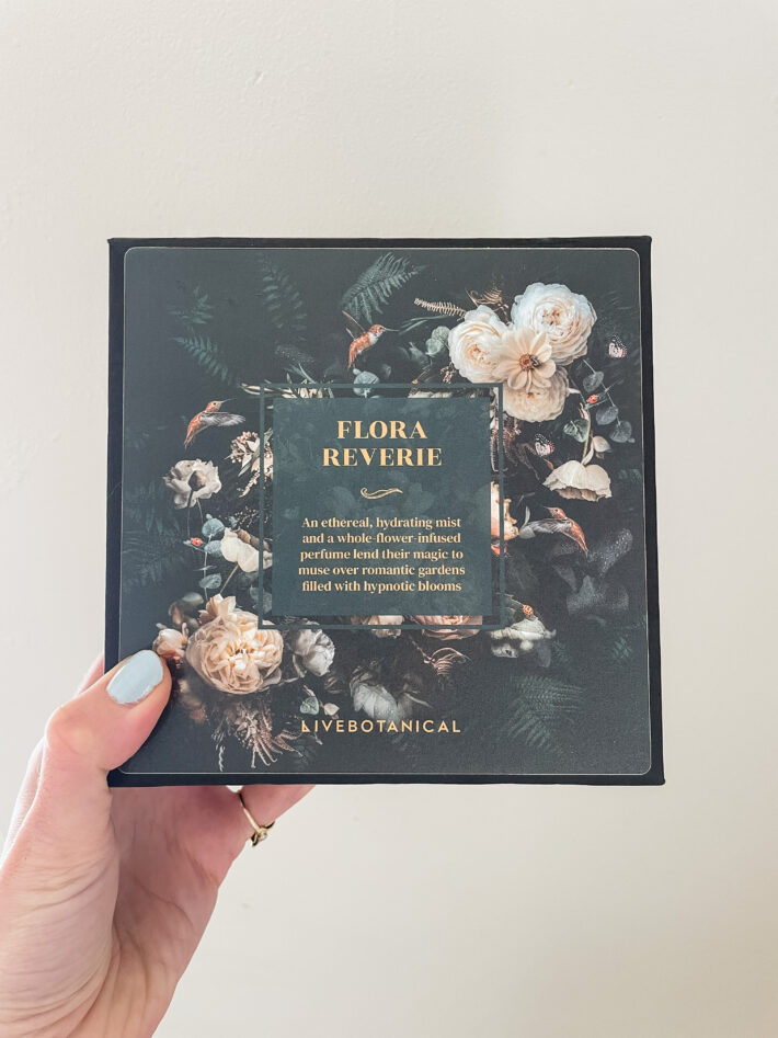 A hand holds up a box of Flora Reverie from Live Botanicals.