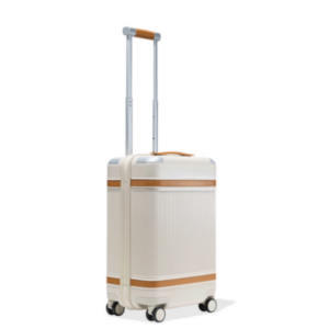 A creamy white suitcase with tan bands on it.
