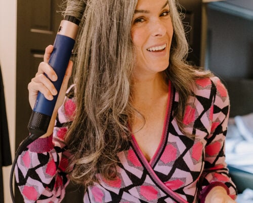 A woman curls her hair with the Dyson Airwrap