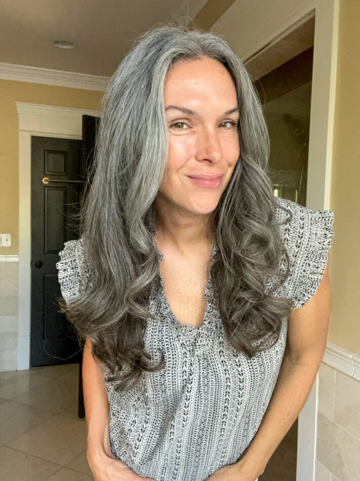 A woman's long gray hair right after using the Dyson Airwrap.
