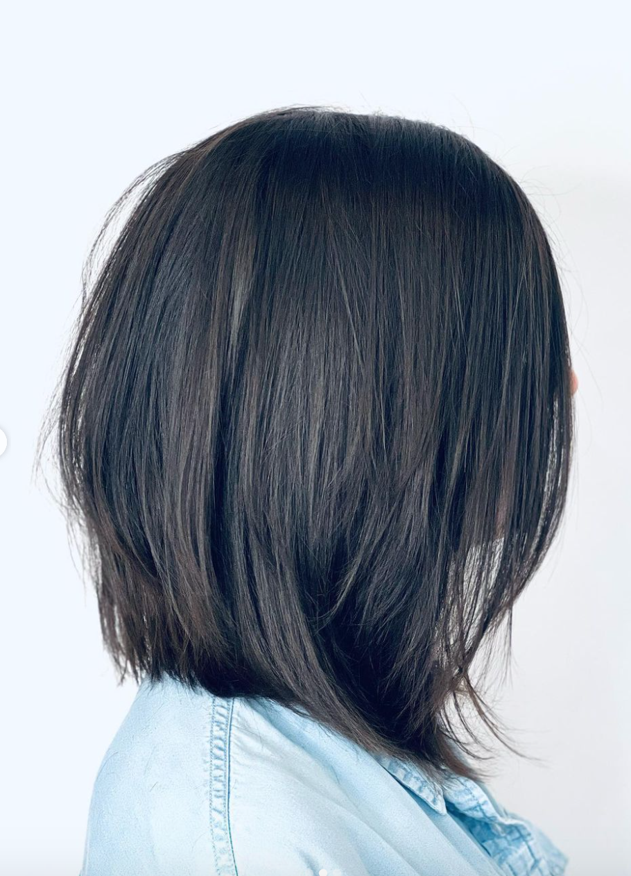 The side view of a woman with black hair. 