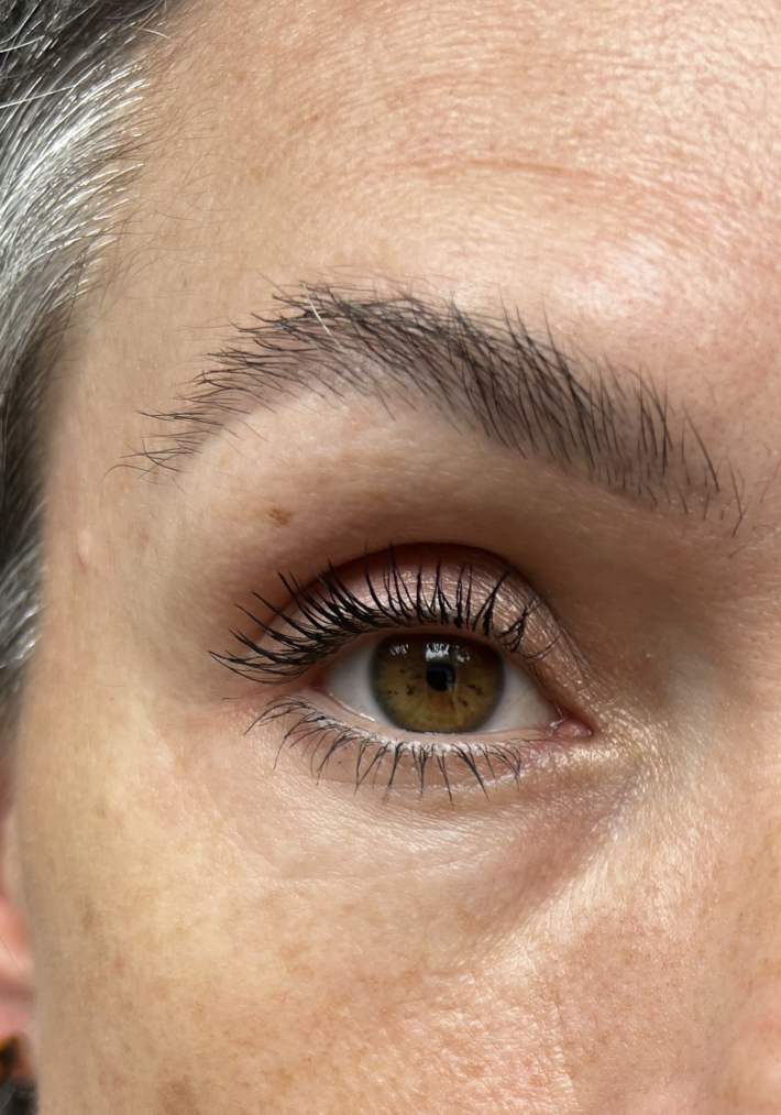 A close up of a woman's eye wearing mascara. 