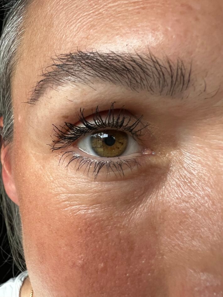 A close up of a woman's eye wearing mascara. 