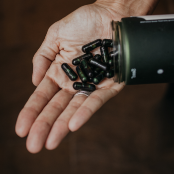 probiotic capsules being poured into hand