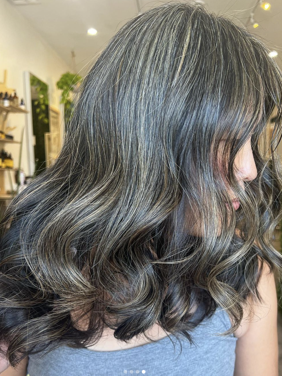 The side view of a woman's hair after gray blending.