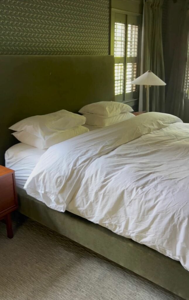 A bed with Brooklinen percale sheets.