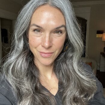 A woman with long wavy gray hair.