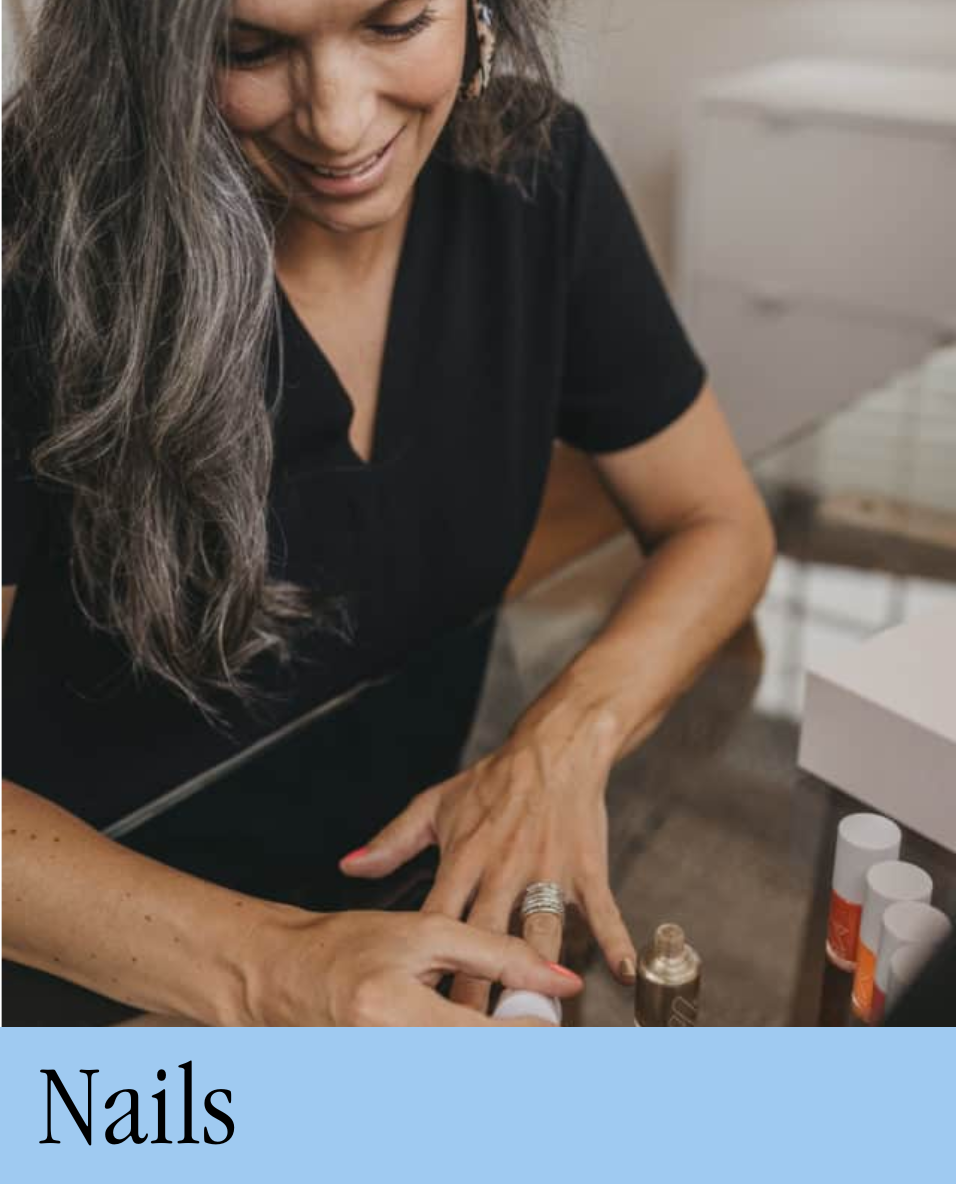 A woman painting her fingernails