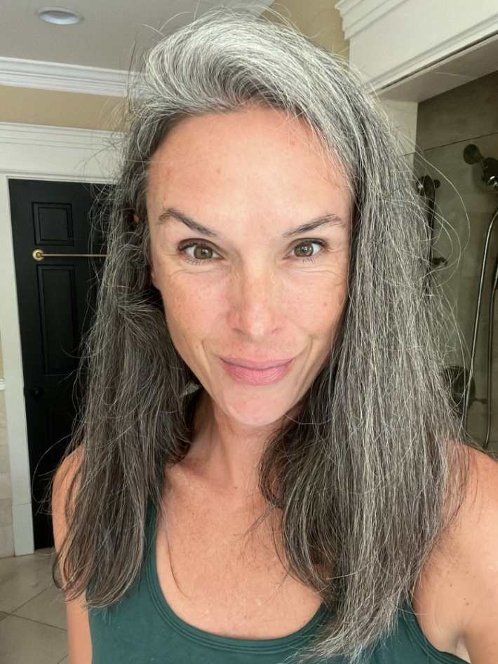 A woman with gray hair before styling with the Shark FlexStyle. 