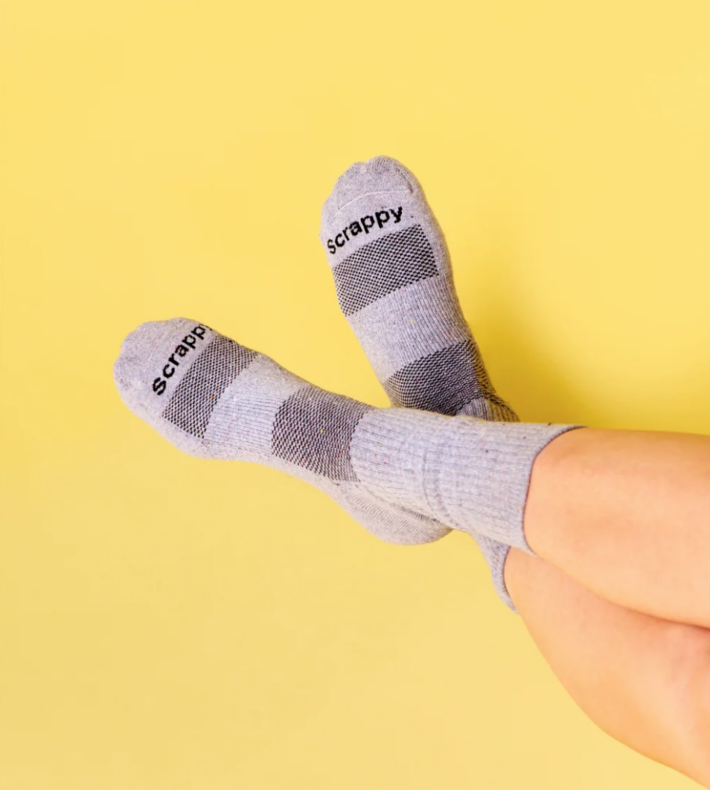 Scrappy Clothing Co. socks on a person. 