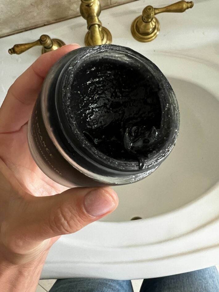 A small tub of clean beauty exfoliating cream.