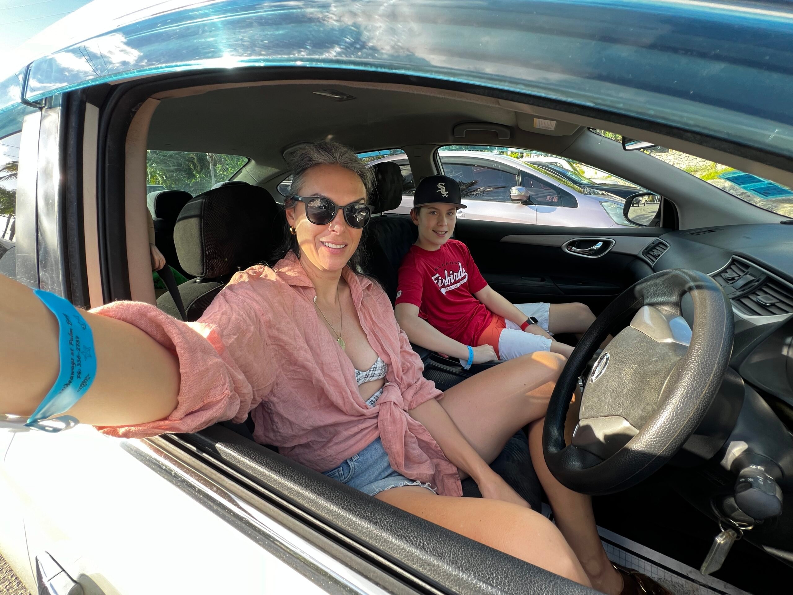 A woman and her son in a rental car.