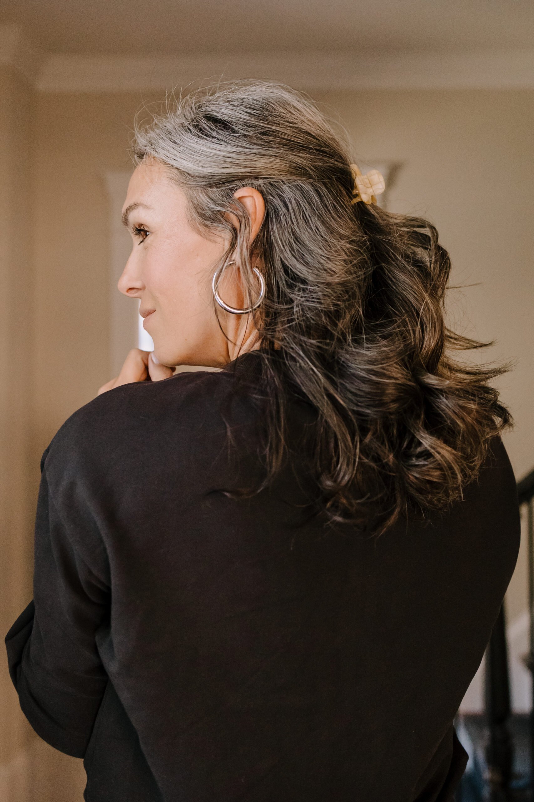 A woman with her hair pulled back in a claw clip.