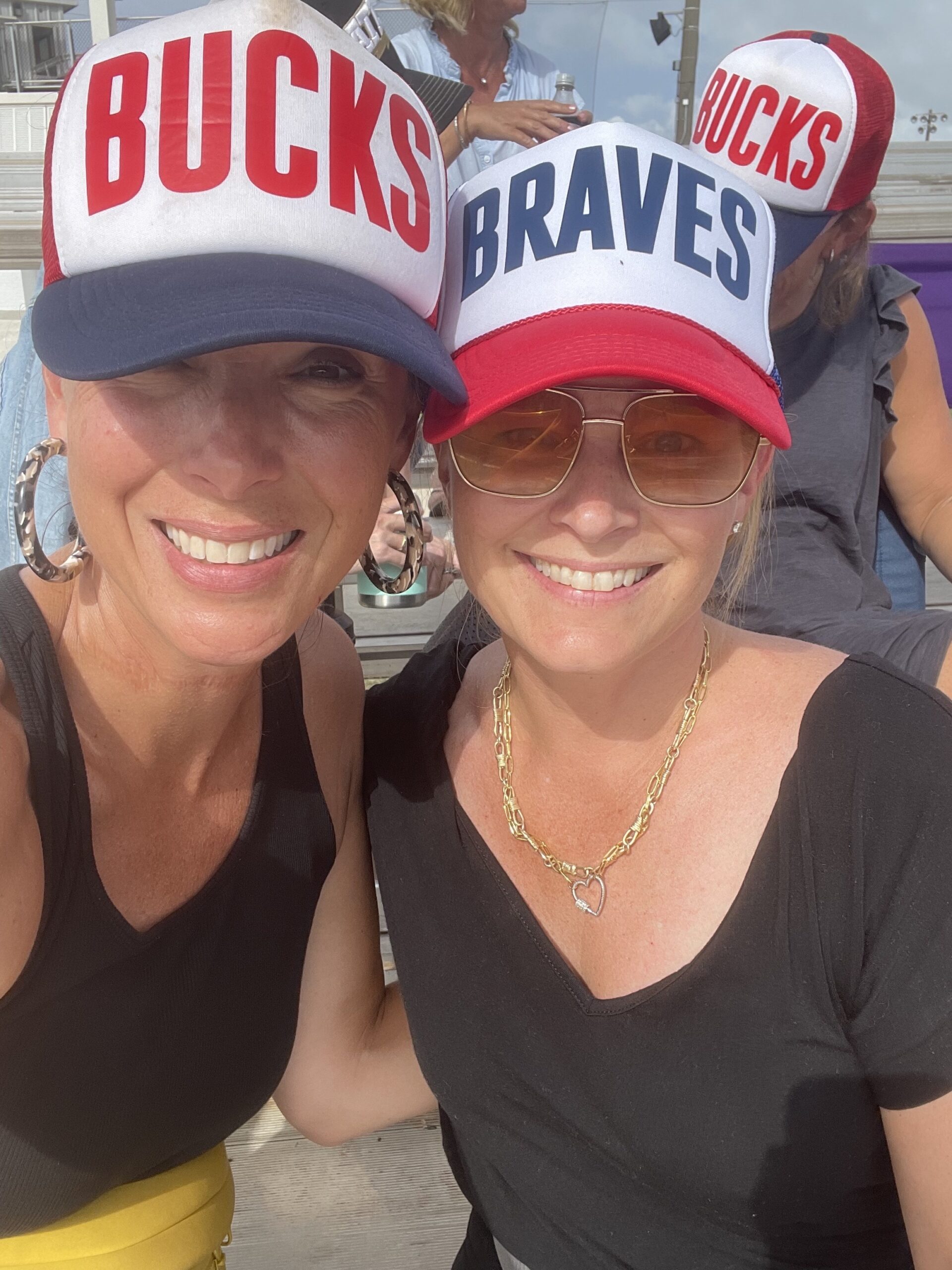 Two women in custom trucker hats.