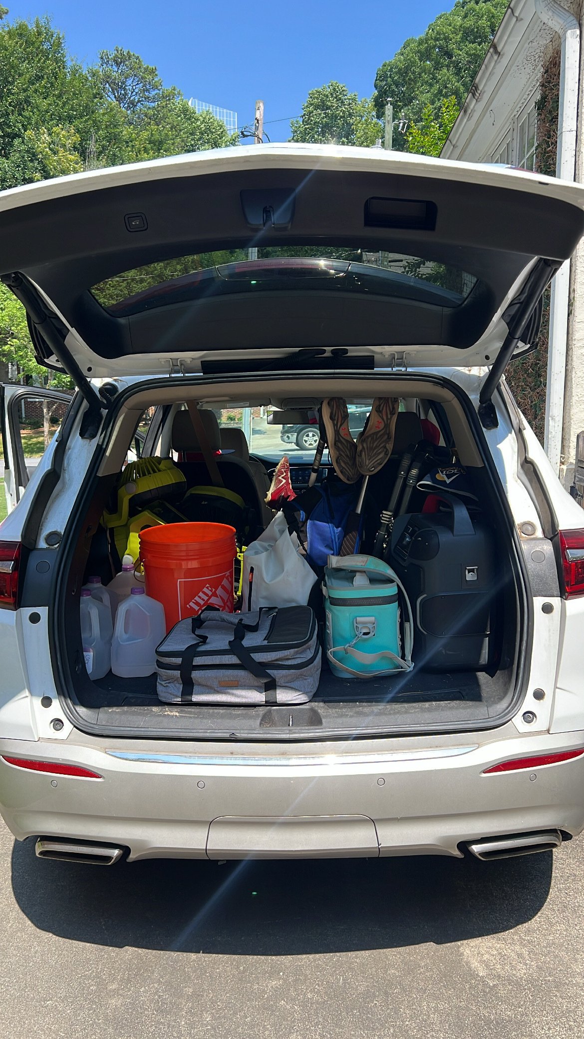 A trunk filled with baseball equipment and essentials. 