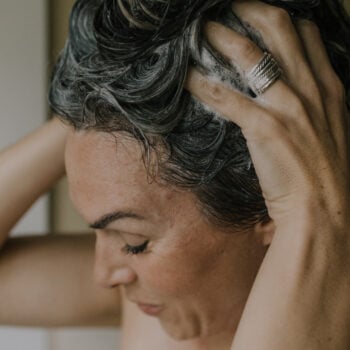 A woman shampooing her hair.
