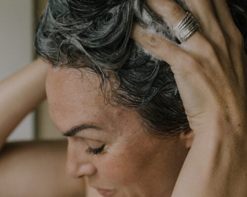 A woman shampooing her hair.