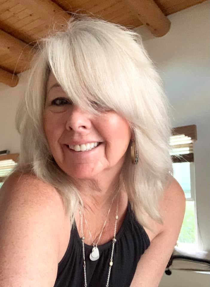 A selfie of a woman with white hair.